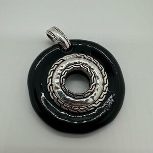 Black donut shape plastic silver tone pendant